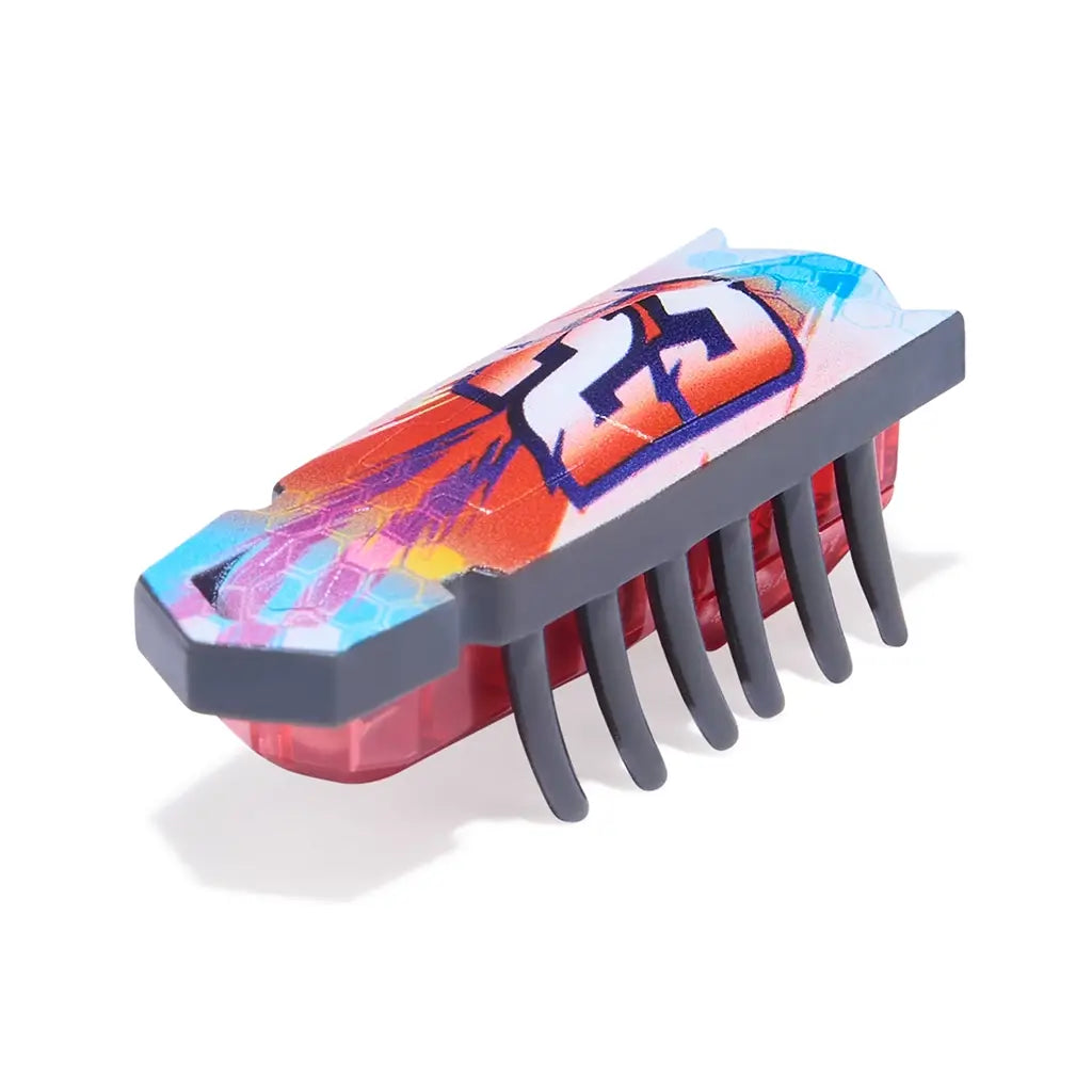 HEXBUG Nano toy robot bright multicolor plastic shell with red translucent base and black rubber legs in a low rectangular insect-like form designed for fast crawling motion, displayed on a clean white background