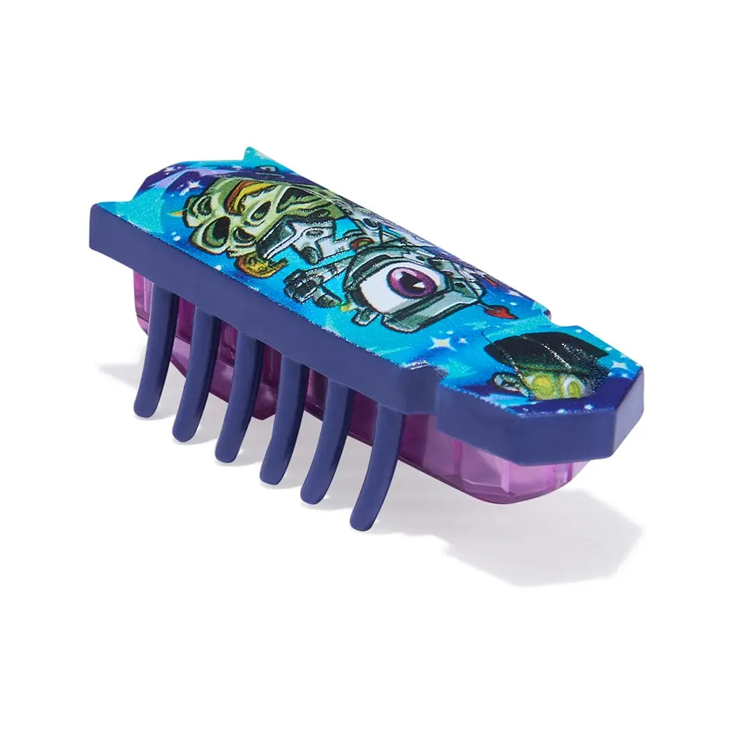 HEXBUG Nano robot bug angled view showing blue and purple plastic body with printed character design, low-profile rectangular shape and flexible legs, designed for interactive play on a white backdrop.