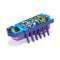 HEXBUG Nano robot bug in blue, purple, and green plastic with textured top graphic, low rectangular body and multiple rubber legs, designed for fast crawling motion on a neutral white surface.