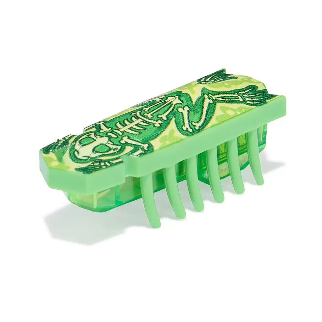 HEXBUG Nano toy robot bright green plastic body with skeleton frog graphic and translucent base, shown in an angled view highlighting compact insect-like shape and flexible legs for crawling play on white background