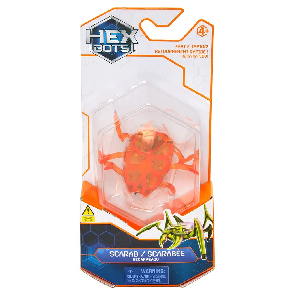 Hex Bots scarab robot toy in vivid orange translucent plastic with faceted shell and articulated legs, compact hexagonal form for flipping action, shown in front-facing retail package on white background