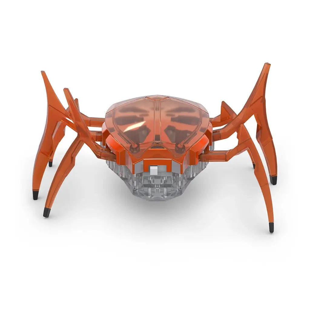 Hex Bots scarab robot in bright orange translucent plastic with low-profile oval shell and six jointed legs, compact motorized toy designed for rapid flipping movement, centered on white background