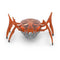 Hex Bots scarab robot in bright orange translucent plastic with low-profile oval shell and six jointed legs, compact motorized toy designed for rapid flipping movement, centered on white background