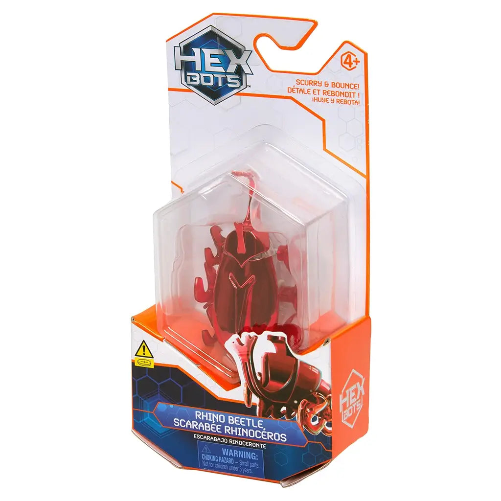 Red robotic beetle toy HEX BOTS in clear plastic retail packaging, glossy smooth shell, curved body and horned front, motorized crawling insect design, displayed on white background.