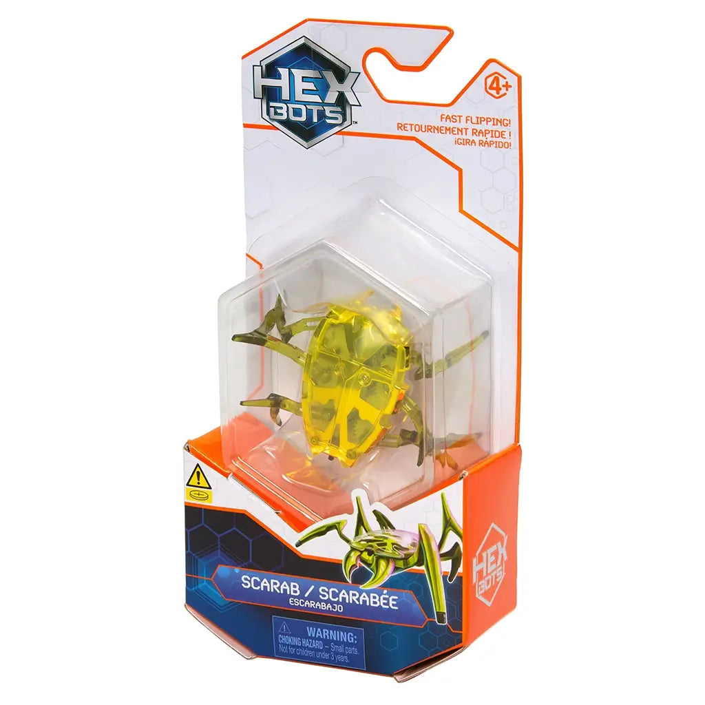 Hex Bots scarab robot toy in bright yellow translucent plastic with angular shell and six pointed legs, motorized for fast flipping action, displayed in clear retail packaging on white background