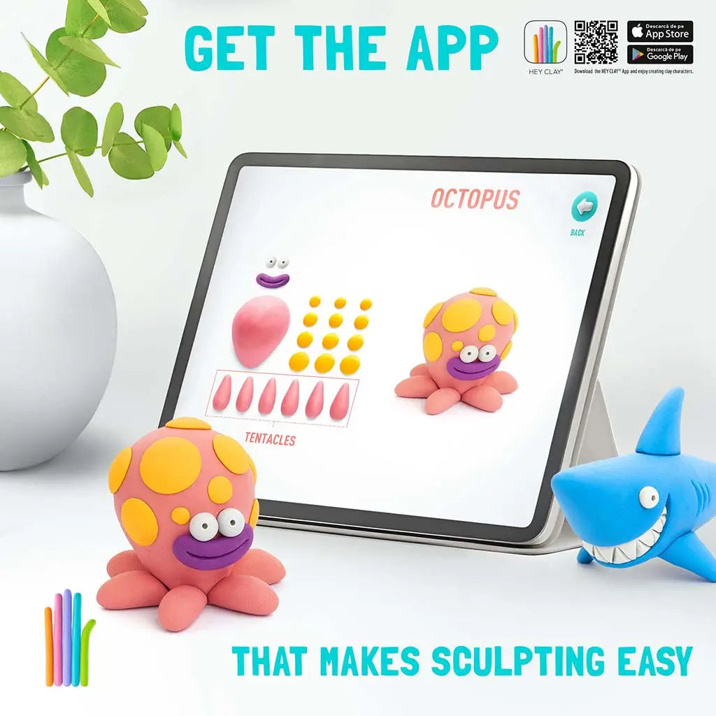 Hey Clay ocean app demo on a tablet displaying step-by-step octopus shapes, shown next to finished clay models and a smiling blue shark figure on a bright tabletop scene.