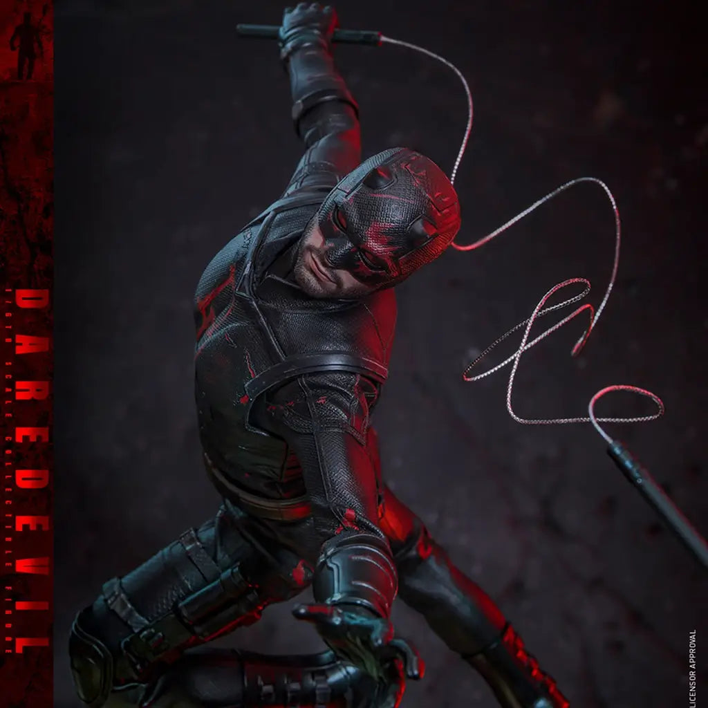 Hot Toys Marvel sixth-scale figure in black textured armor with red accents poses dynamically with a masked head, raised baton and looping cable against a dark backdrop.