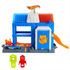 Hot Wheels City Downtown Police Tower playset in blue and gray plastic with orange ramp, rotating rooftop arms, police badge door, and included police car, designed for vehicle launch and capture play.