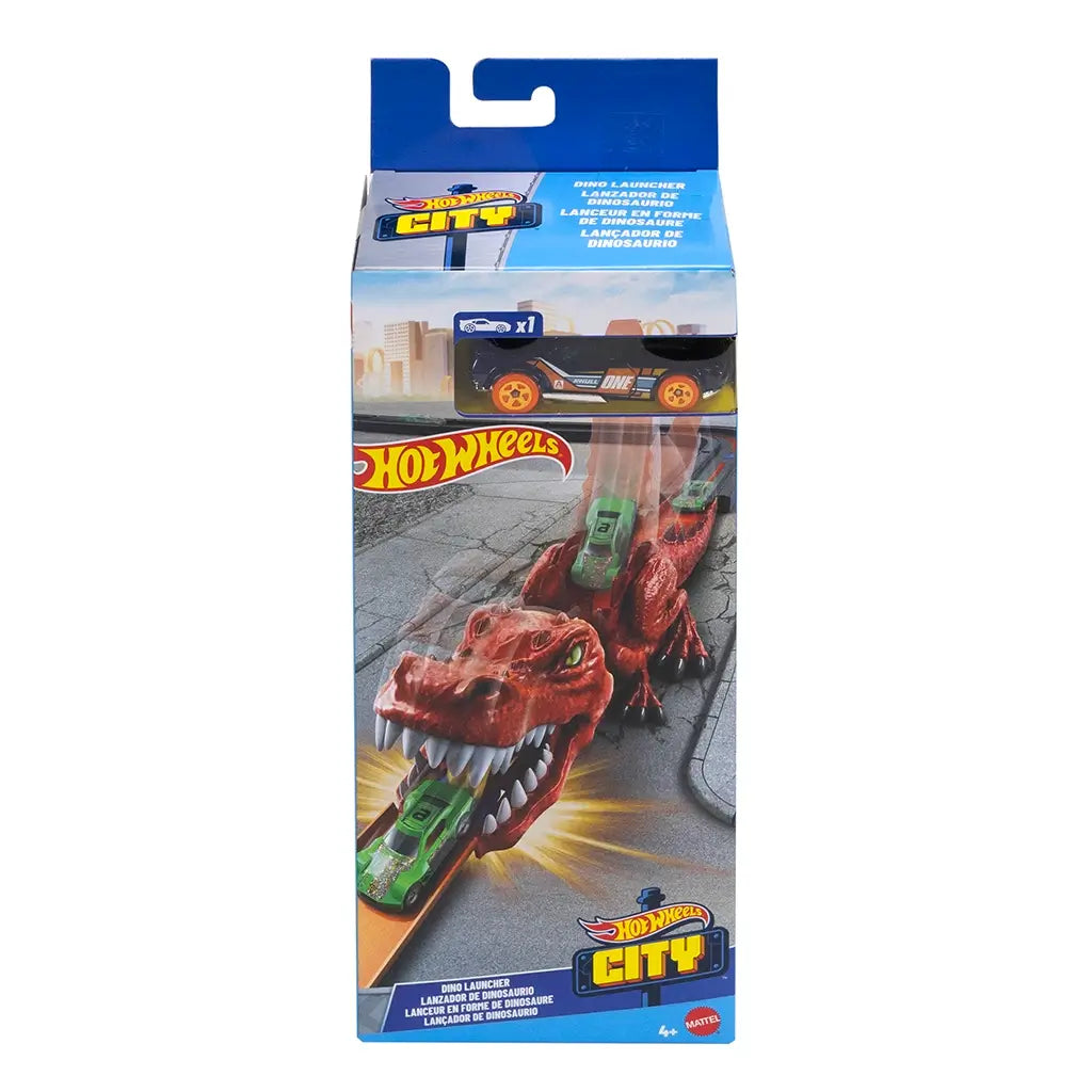 Retail packaging of Hot Wheels City Nemesis Dino Launcher playset showing the red dinosaur toy with a green Hot Wheels car racing through its mouth, branded box in blue and yellow.