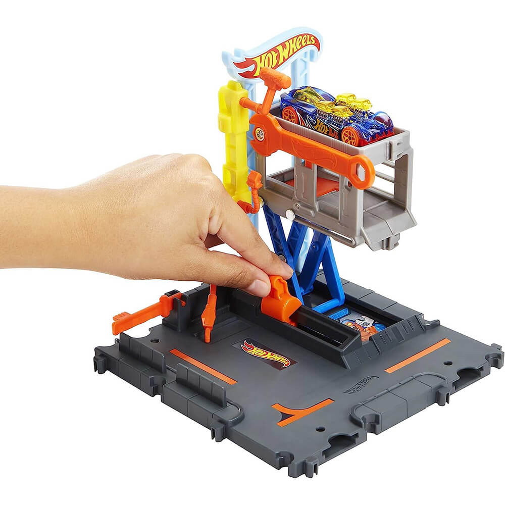 Hot Wheels City Tune Up Garage Playset with hand shown moving car up