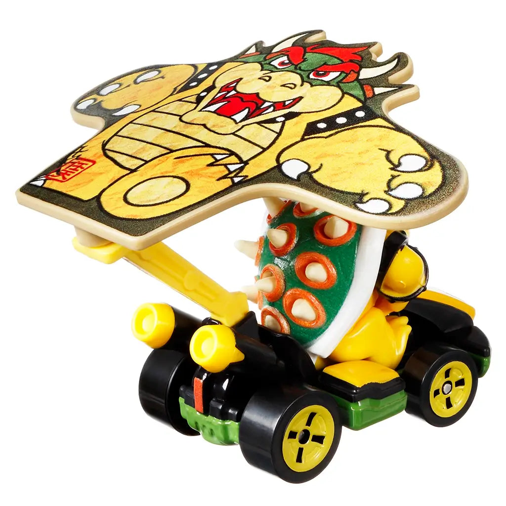 Rear angled view of Hot Wheels Mario Kart Bowser diecast kart highlighting Bowser’s spiked green shell, black exhaust pipes, yellow wheels, and large kite-shaped glider.