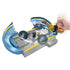 Action view of Hot Wheels Mario Kart Chain Chomp Track Set with hand pressing Mushroom Slam Launcher, propelling Donkey Kong’s kart across gray ramp past spinning Chain Chomp.