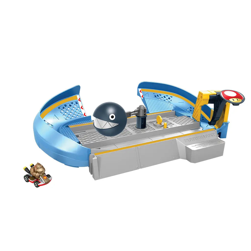 Hot Wheels Mario Kart Chain Chomp playset showing blue curved track with gray base, Donkey Kong die-cast kart, spinning black Chain Chomp figure, and coin detail in center.