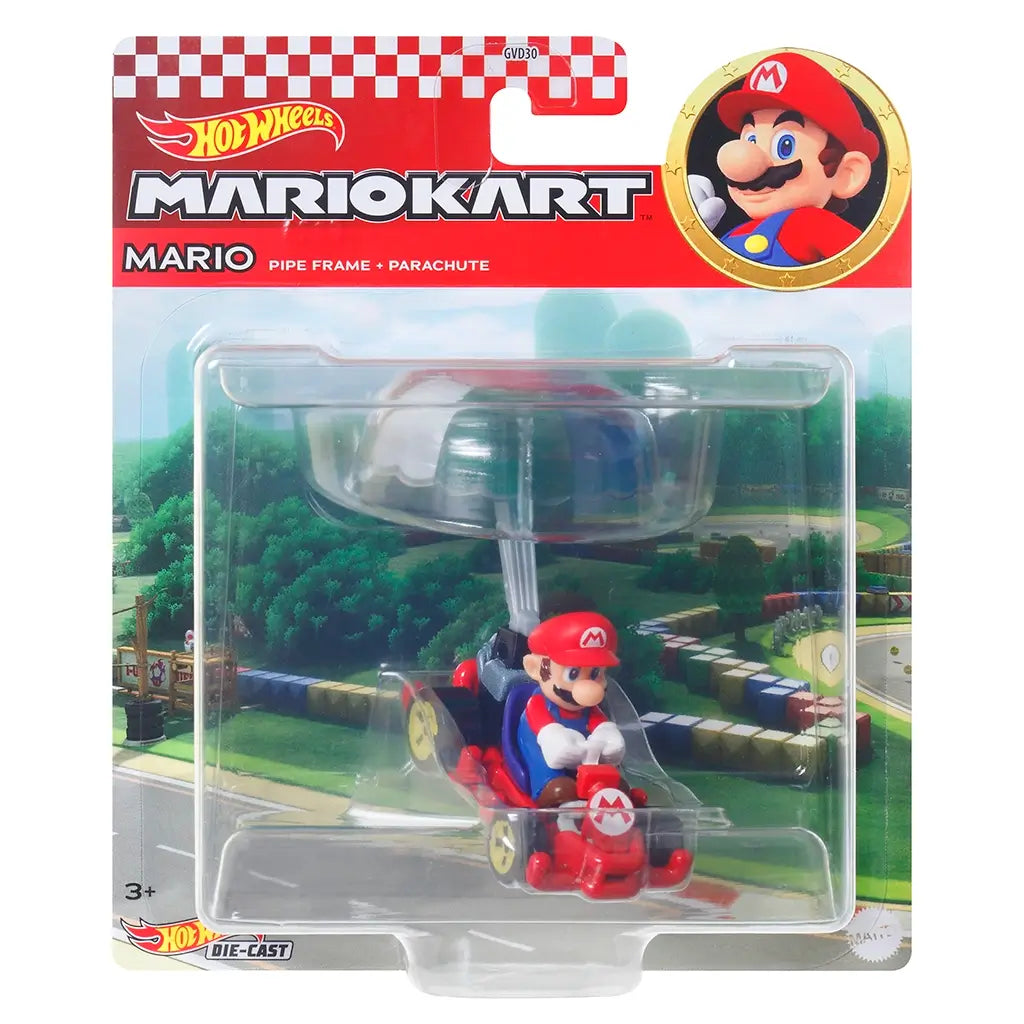 Sealed retail package of Hot Wheels Mario Kart diecast featuring Mario in a red kart with rainbow parachute glider, displayed against a racetrack background.