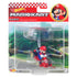 Sealed retail package of Hot Wheels Mario Kart diecast featuring Mario in a red kart with rainbow parachute glider, displayed against a racetrack background.