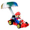Front angled view of Hot Wheels Mario Kart diecast toy with Mario in a red kart, wearing his red cap and gloves, steering under a colorful parachute glider.