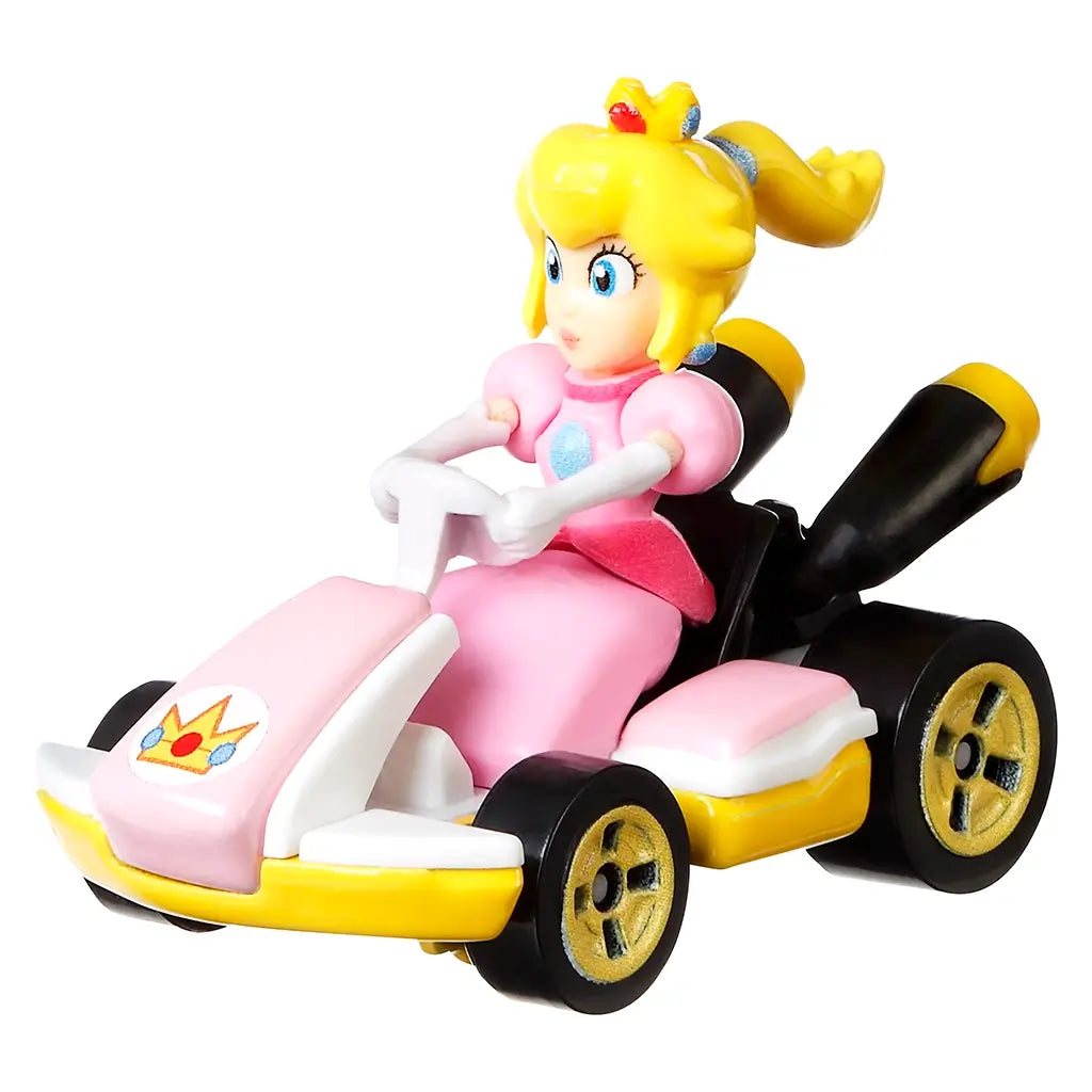 Hot Wheels Mario Kart Princess Peach Standard Kart shown in a pink, yellow, and black plastic finish, angled to highlight the molded figure, steering wheel, gold wheels, and low-profile kart design on a white backdrop.