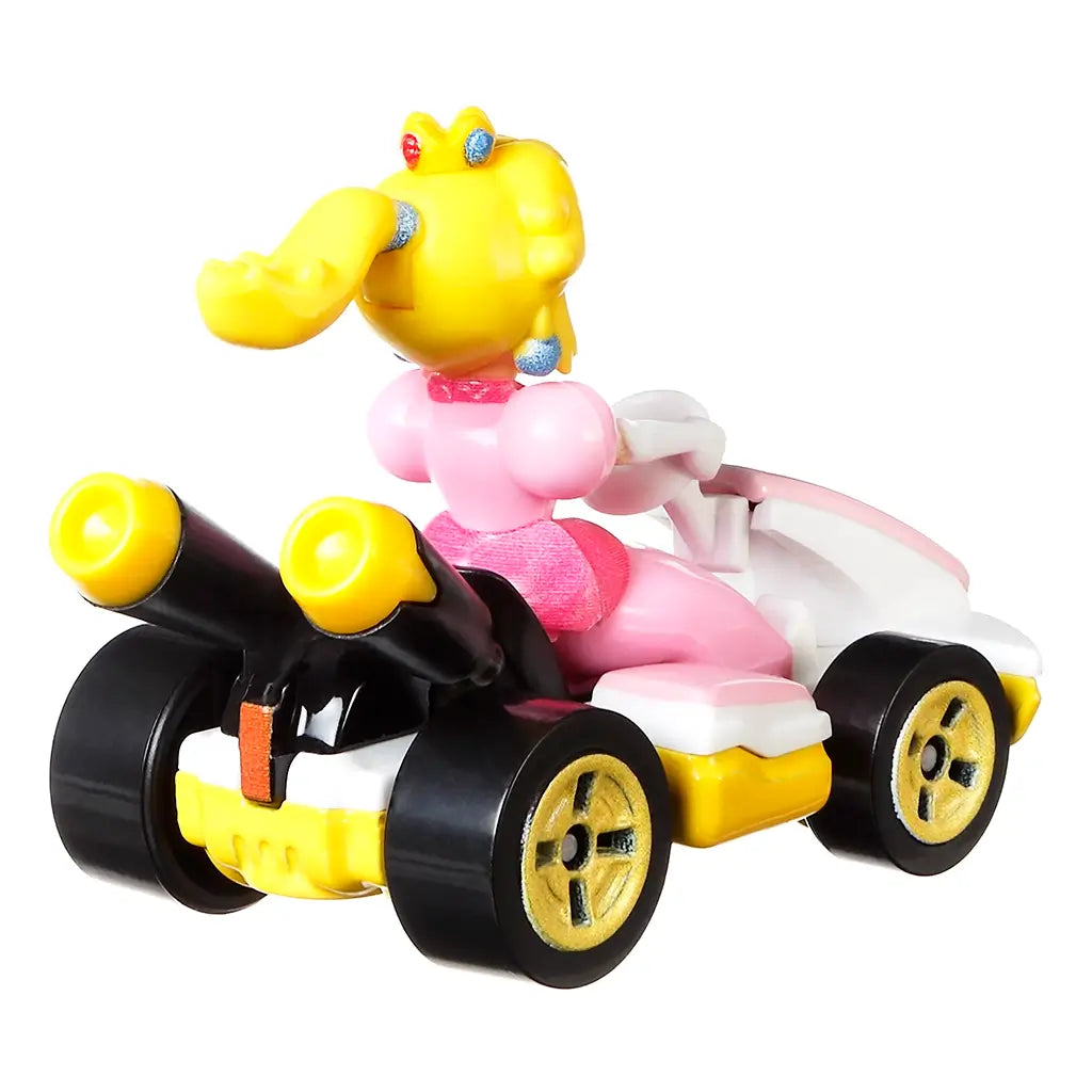 Hot Wheels Mario Kart Princess Peach Standard Kart rear view in pink, yellow, and black plastic, showing twin exhaust pipes, gold wheels, seated figure details, and compact kart form against a bright white background.