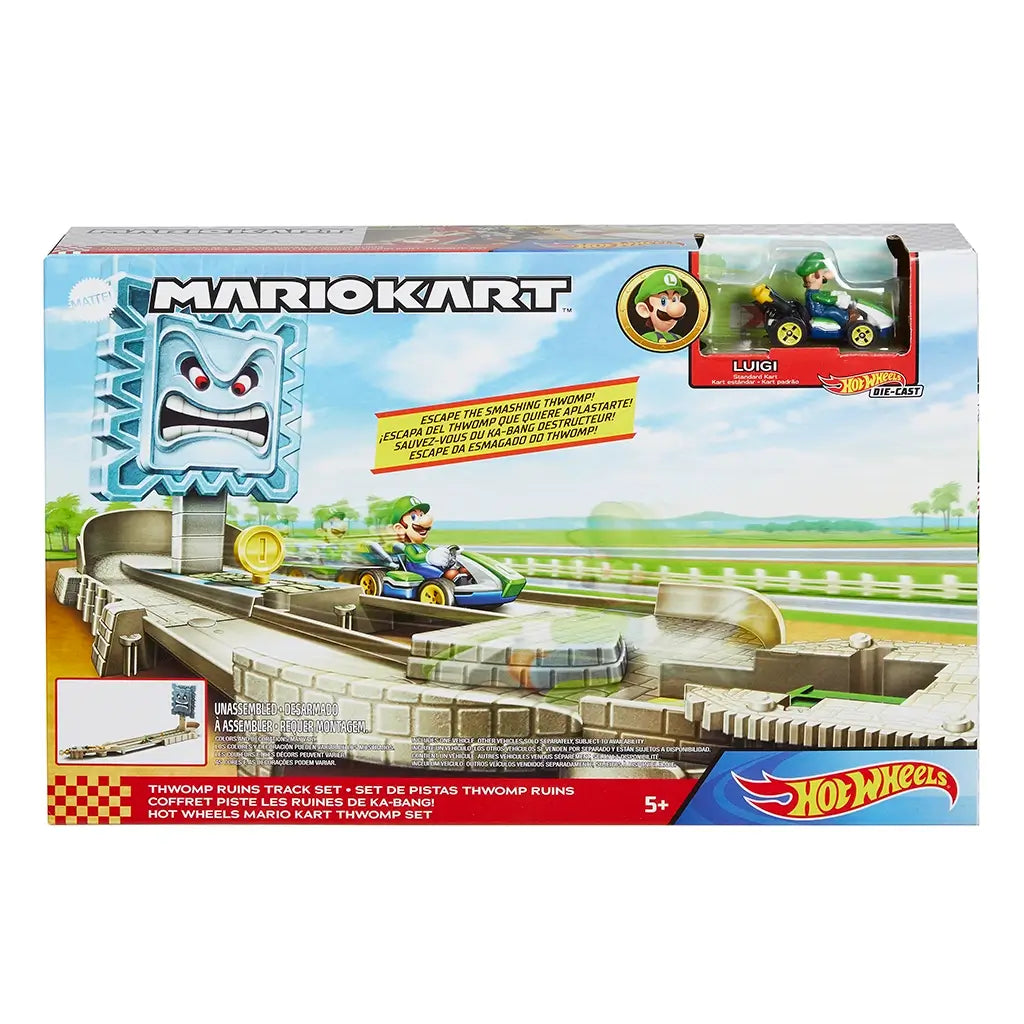 Box of Hot Wheels Mario Kart Thwomp Ruins playset shows Luigi in a green kart racing under a gray Thwomp block, with bright graphics and bilingual text highlighting the track features.