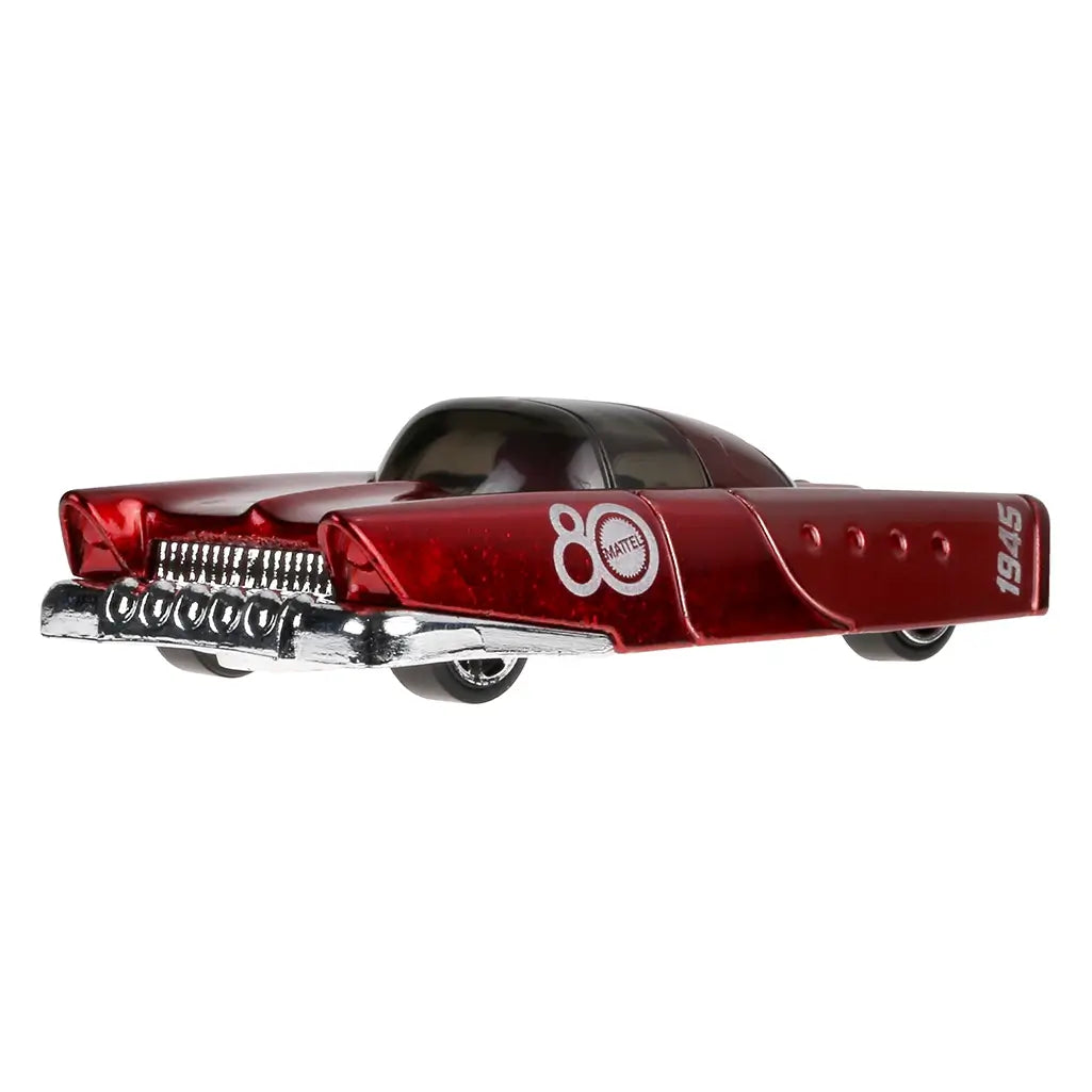 Rear view of red Mattel Dream Mobile Hot Wheels car with chrome exhaust pipes and 80th anniversary branding, 1:64 scale collectible die-cast toy vehicle.
