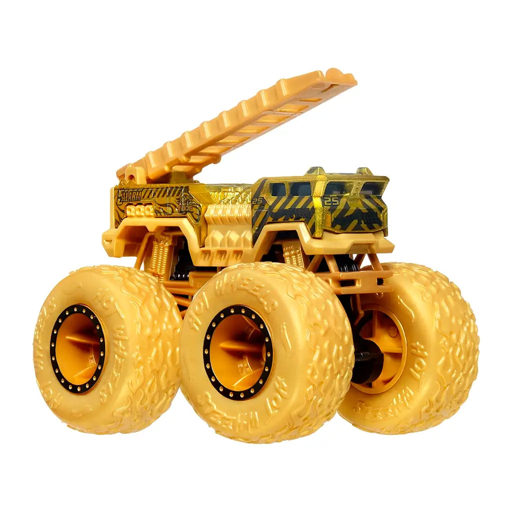 Gold Hot Wheels 5 Alarm monster truck with ladder extended, featuring black and yellow fire truck detailing and oversized tires for action play.