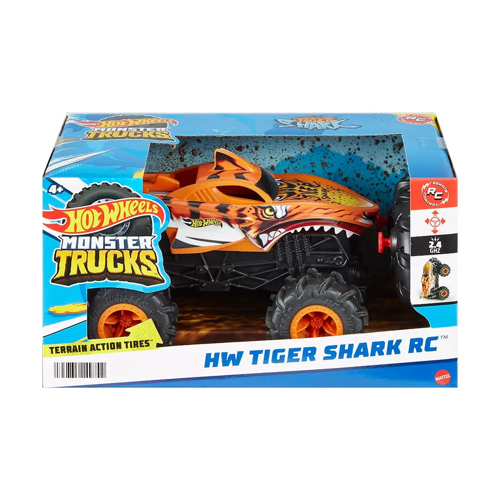 Hot Wheels Monster Trucks Tiger Shark RC in original packaging, featuring bold tiger shark graphics, large orange wheels, and text promoting terrain action tires and 2.4 GHz control.