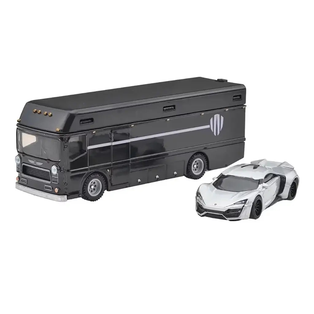 Hot Wheels Euro Hauler and Lykan Hypersport appear side-by-side, showing the sleek silver supercar and the black hauler’s long, angular body with subtle graphics on a clean white background.