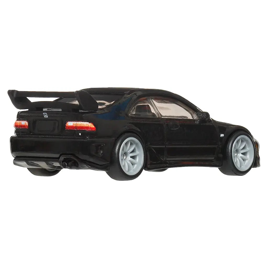 Hot Wheels Honda Civic diecast car in glossy black metal with sculpted rear bumper, twin exhaust detail, red tail lights, silver wheels, and large rear spoiler, shown from a rear angled view on a white background.