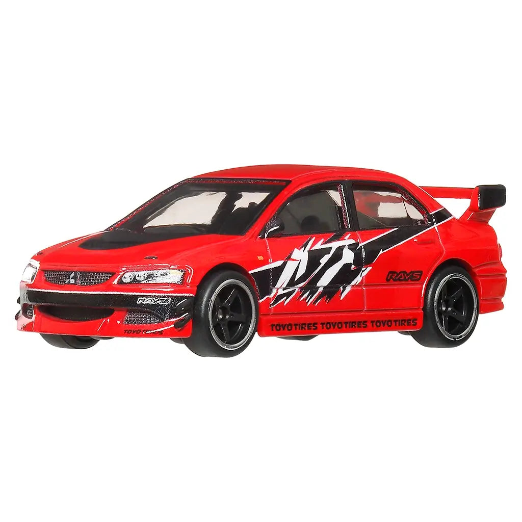 Hot Wheels Mitsubishi Lancer Evolution IX diecast car in bright red metal with detailed racing livery, low sporty stance, black multi-spoke wheels, front splitter, and large rear wing, shown at an angled view on white.