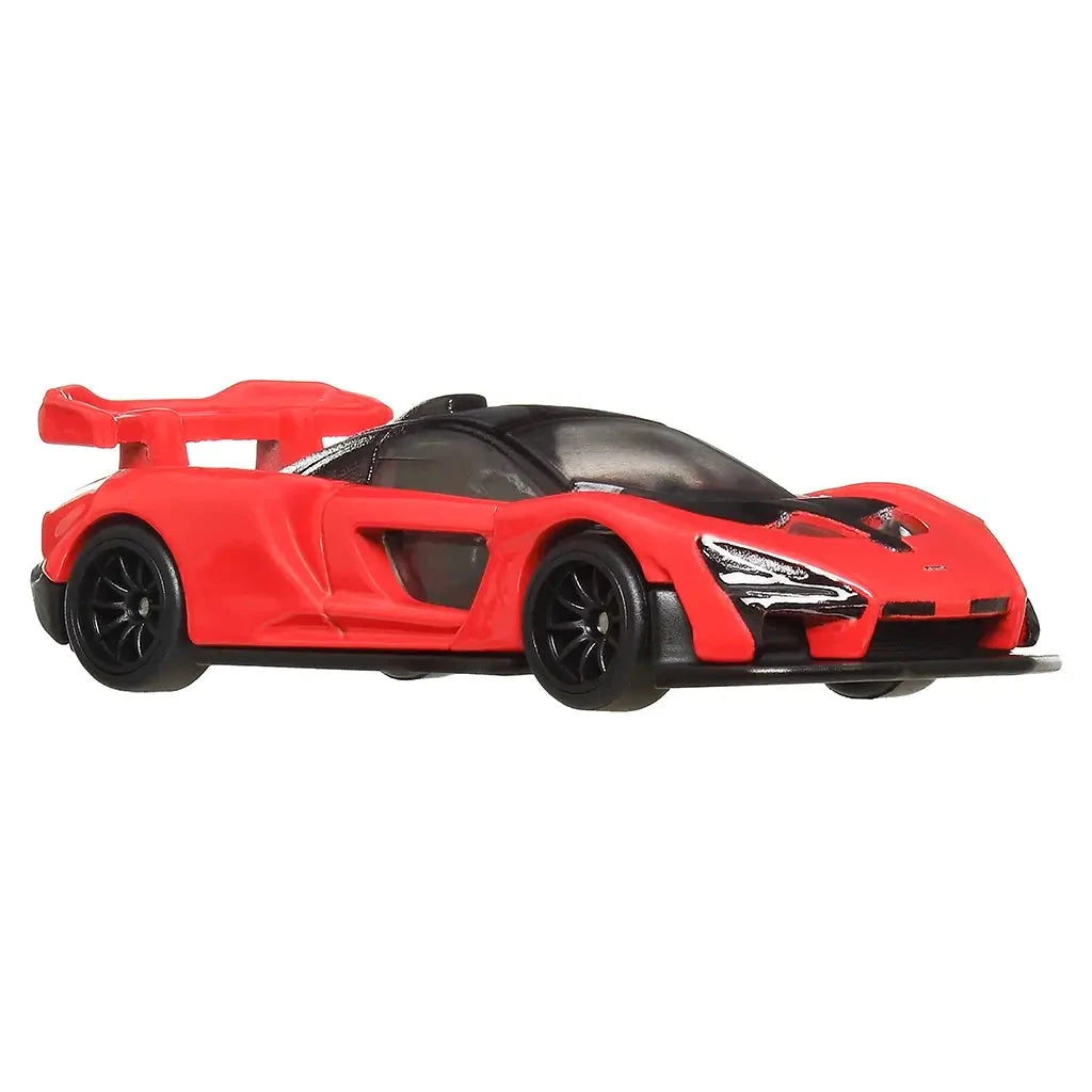 Front side angled view of Hot Wheels McLaren Senna die-cast car in red with black details, sleek headlights, and sporty low profile.