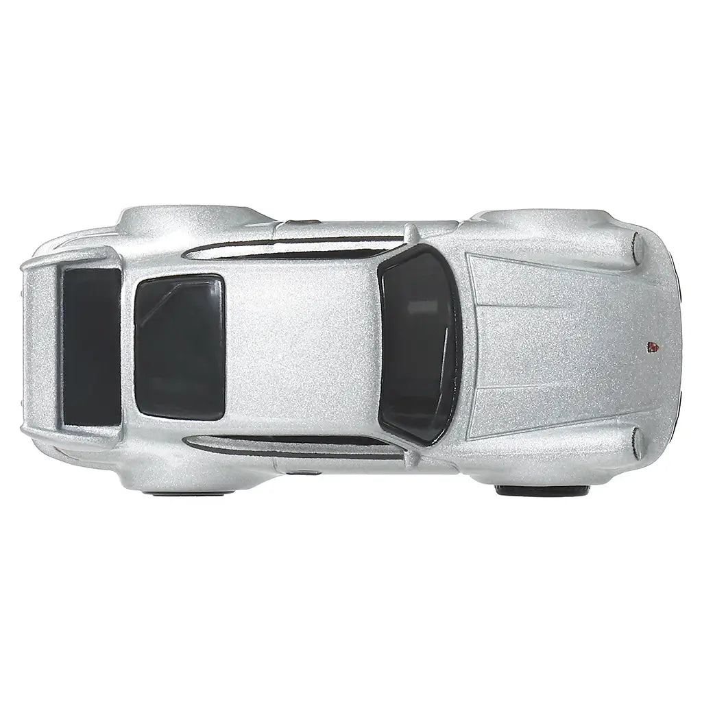 Hot Wheels Porsche 911 Carrera RS 3.8 diecast car in metallic silver metal with smooth roof panel, sculpted hood lines, rear spoiler outline, compact sports car proportions, shown from a top-down view on white.
