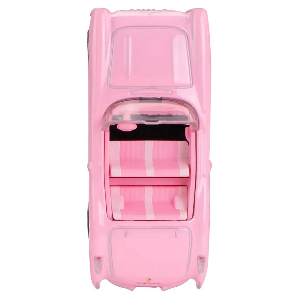 Top view of Hot Wheels Barbie 1956 Corvette model, showcasing pink body, white-striped seats, and glitter detail along side coves.