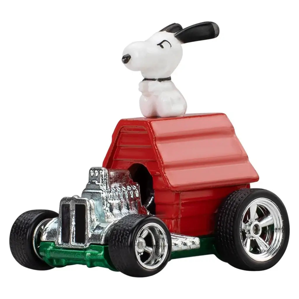 Hot Wheels Premium Snoopy vehicle featuring a red die-cast metal doghouse body, glossy chrome hot rod engine, rounded cartoon proportions, and a white Snoopy figure seated on top, styled as a Peanuts Pop Culture collectible on a white background.