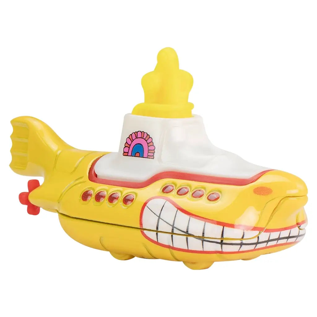 Yellow die-cast Hot Wheels Beatles Yellow Submarine toy with smooth finish, smiling bow design, red portholes, white conning tower, and bright yellow propellers.