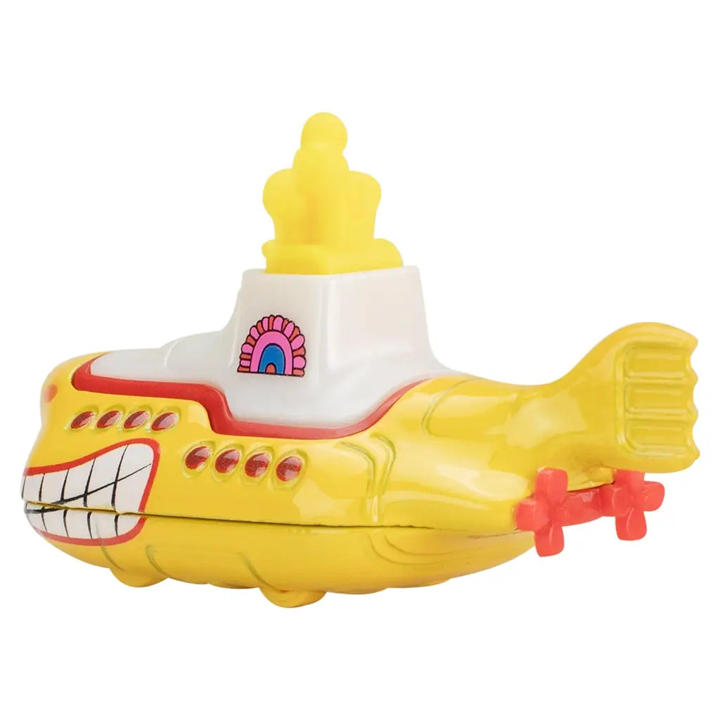 Rear angled view of Hot Wheels Beatles Yellow Submarine toy with dual red propellers, yellow hull, curved tail fin, white conning tower, and smiling bow artwork.