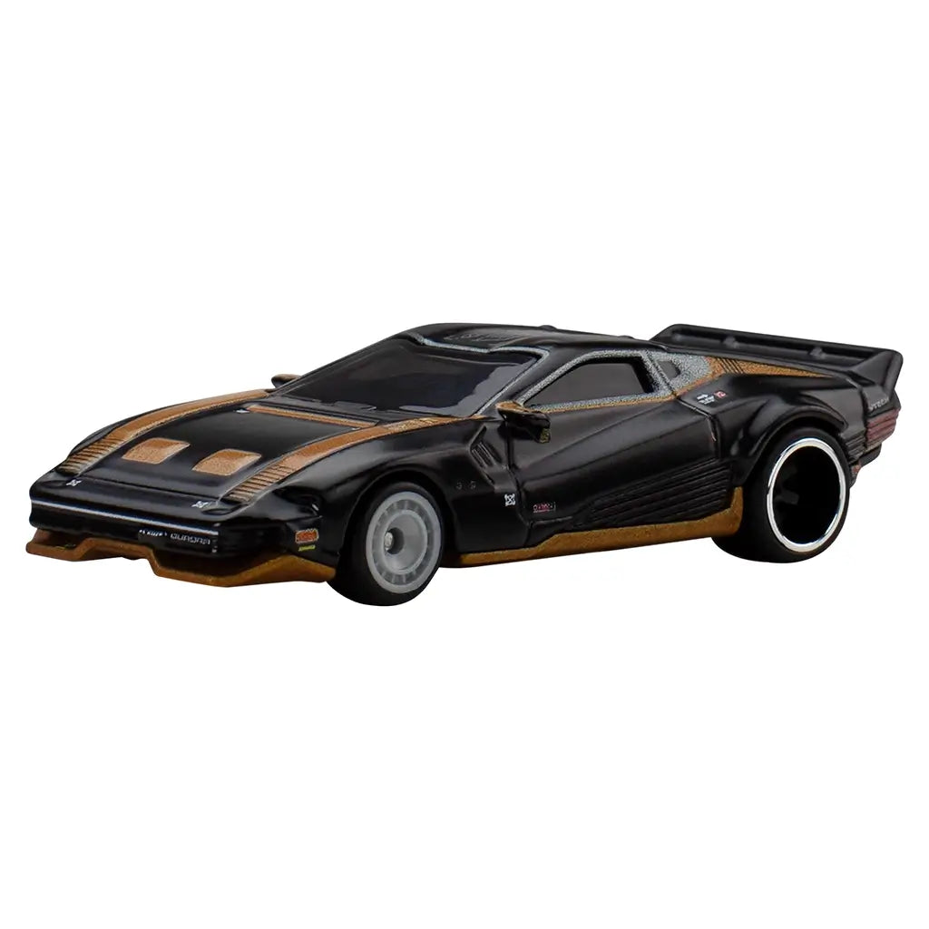 Hot Wheels Premium Quadra Turbo-R V-Tech diecast car in glossy black with metallic gold accents, low wedge-shaped body, wide rear tires, and futuristic detailing inspired by Cyberpunk 2077 styling.