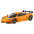 Angled view of Hot Wheels 1995 McLaren F1 GTR die-cast car in orange, highlighting sleek aerodynamic design, black spoiler, vented hood, and realistic racing details on plain backdrop.