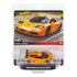 Hot Wheels Premium 1995 McLaren F1 GTR 1:43 scale die-cast car in bright orange with black accents, shown in retail packaging with street background and product branding details.
