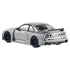 Metallic silver Nismo GT-R LM Hot Wheels diecast viewed from rear angle, showing wide bumper, quad taillights, dual exhaust pipes, and oversized racing spoiler detail.