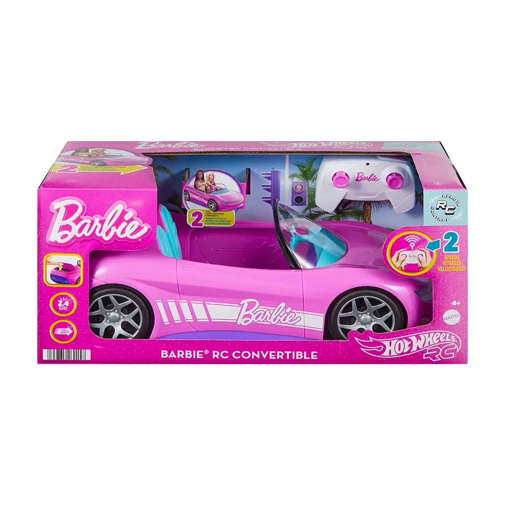 Retail packaging of Barbie Hot Wheels RC convertible car in bright pink box with window display, showing car, remote control, and doll compatibility features.