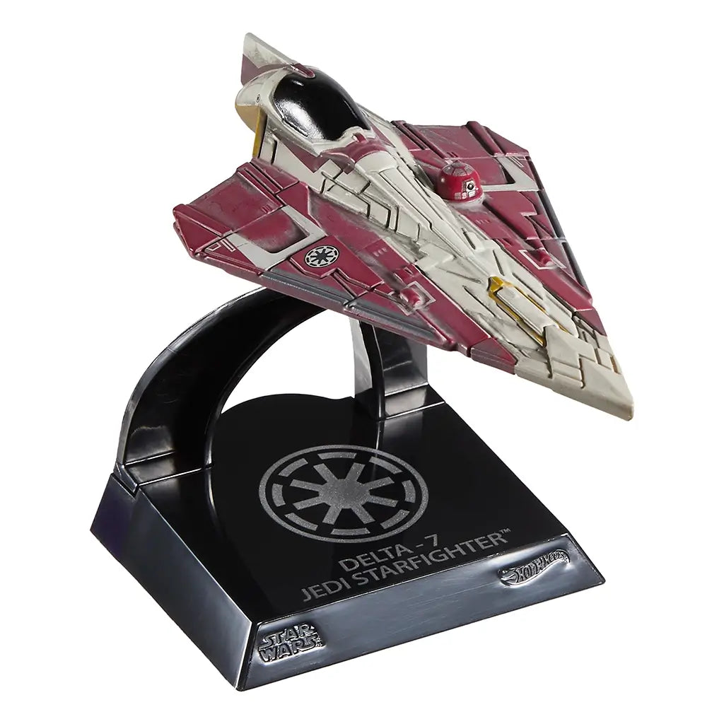 Front-angled view of Hot Wheels Obi-Wan Kenobi’s Jedi Starfighter die-cast model, featuring sleek angular wings, red and ivory coloring, and mounted on a silver Galactic Republic emblem display stand.