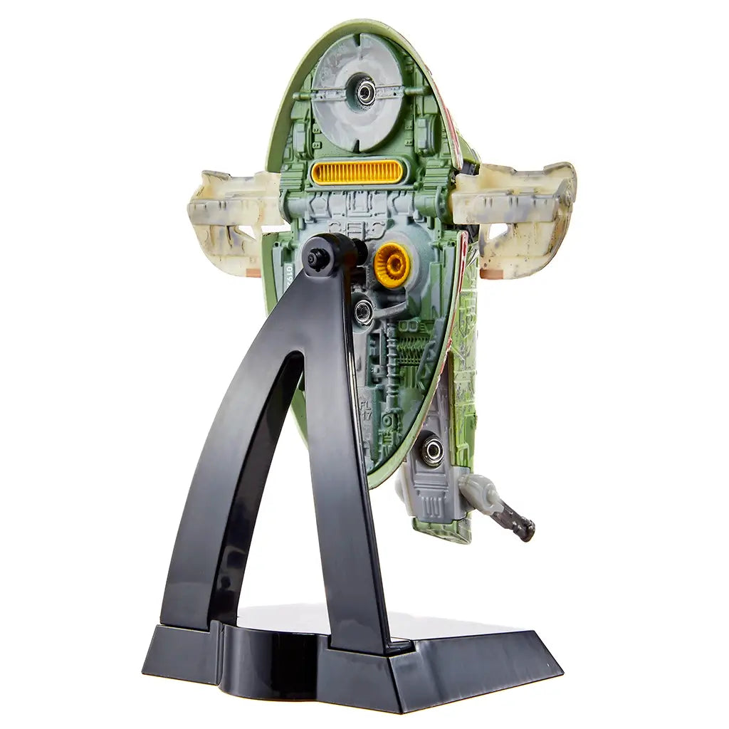 Hot Wheels Star Wars Boba Fett’s Starship rear angled view showing green molded plastic engine details, weathered panel textures, rear thruster design, and black display stand supporting the vertically oriented spacecraft.
