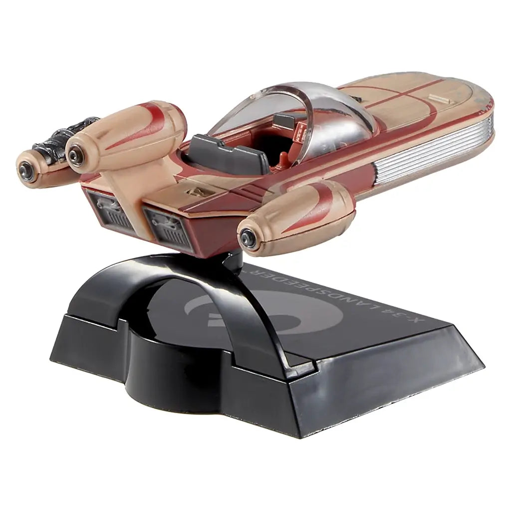 Hot Wheels Star Wars X-34 Landspeeder collectible viewed from behind, featuring dual engine housings, weathered tan and red paint effects, detailed rear panels, and a glossy black base with Star Wars branding.