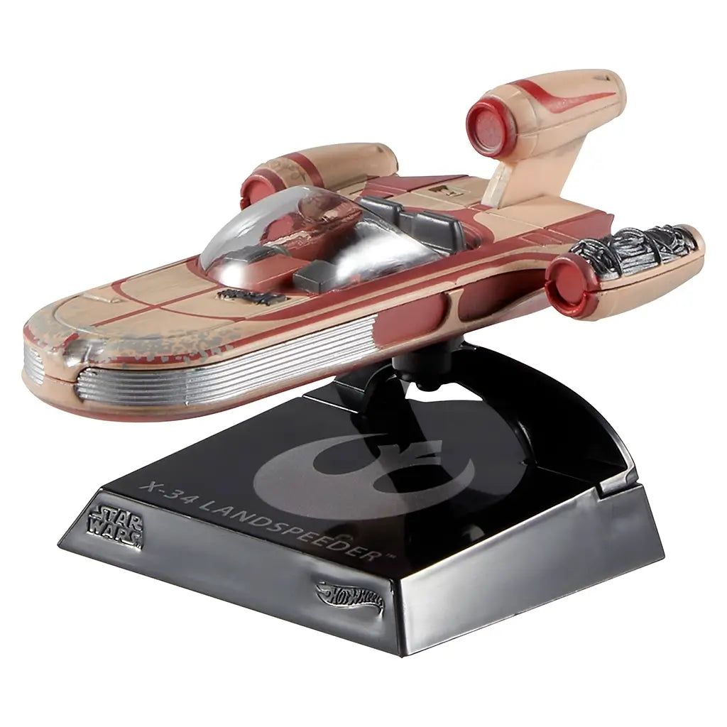 Hot Wheels Star Wars X-34 Landspeeder collectible featuring tan and red weathered plastic body, smooth elongated speeder shape, clear cockpit canopy, and rear engine details, mounted on a black display stand against a white background.