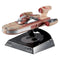 Hot Wheels Star Wars X-34 Landspeeder collectible featuring tan and red weathered plastic body, smooth elongated speeder shape, clear cockpit canopy, and rear engine details, mounted on a black display stand against a white background.