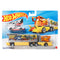 Hot Wheels Galactic Express Super Rigs set featuring a yellow and orange plastic transport truck with a long illustrated trailer, ramp details, and a white race car, displayed in retail packaging on white.