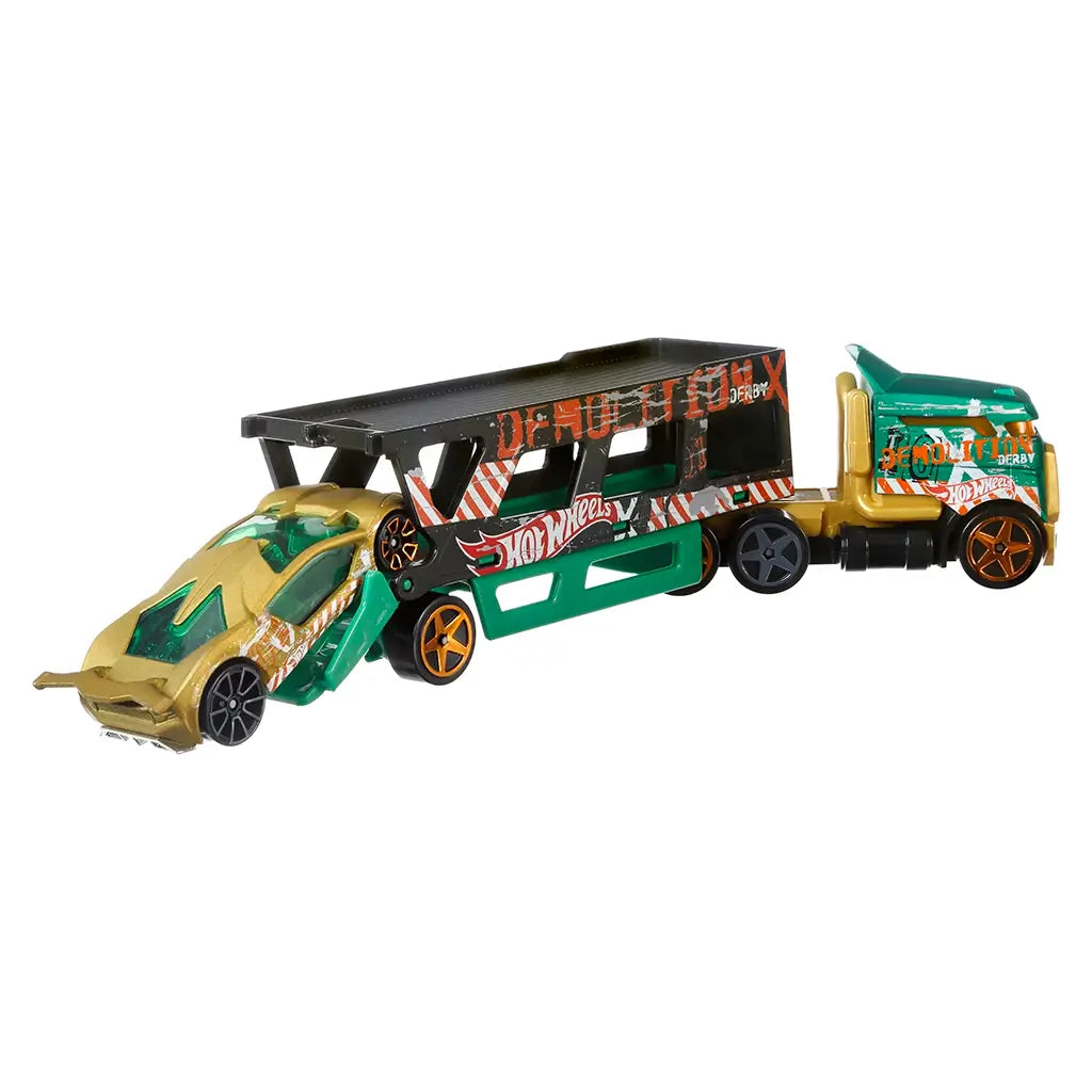 Hot Wheels Super Rigs Road Rally Demolition Derby truck and car in green, black, and gold die-cast metal, showing the loading action as the sports car deploys from the trailer ramp on a clean white background.