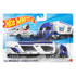 Hot Wheels Tall Order Hauler Super Rigs set featuring a blue and white plastic transport truck with a tall enclosed trailer, angular window cutouts, rolling wheels, and a silver race car displayed in retail packaging.
