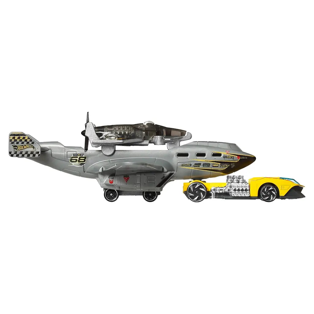Hot Wheels Turbulence Tug Super Rigs set showing a gray airplane styled transport vehicle with black propellers, yellow accents, and a matching yellow race car, displayed side by side on a white background.