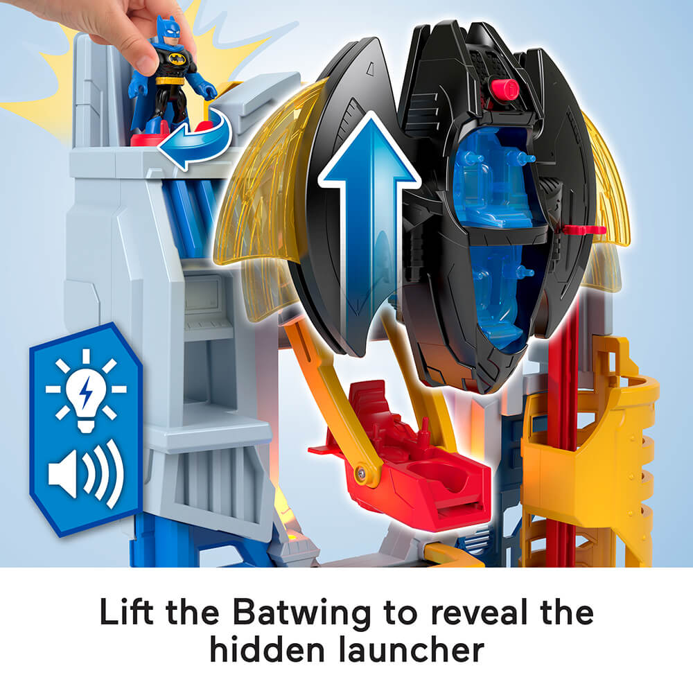 image of the top of the Imaginext DC Super Friends Ultimate Headquarters Hall of Justice Playset stating to lift the batwing to reveal the hidden launcher